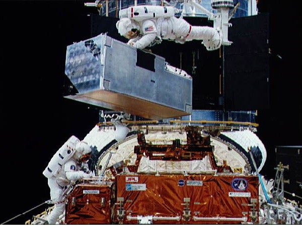 Astronauts working on the Hubble Space Telescope
