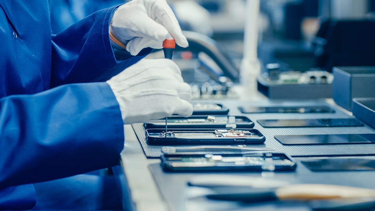 hands repairing smartphone