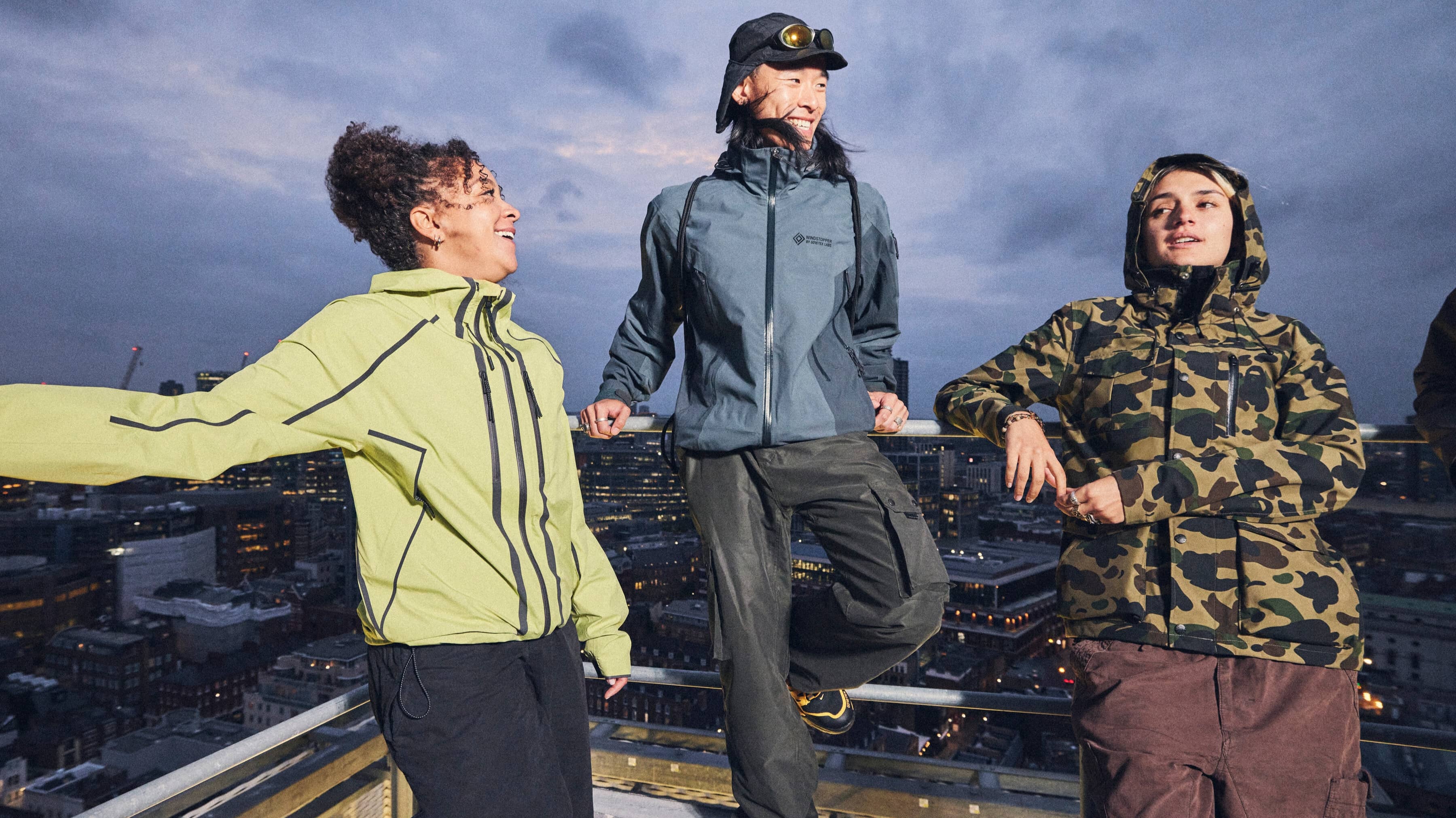 three people on a. city rooftop in Gore-Tex gear
