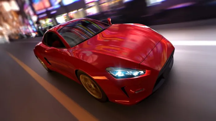 モーションブラーがかかった、都市部を疾走する赤い車