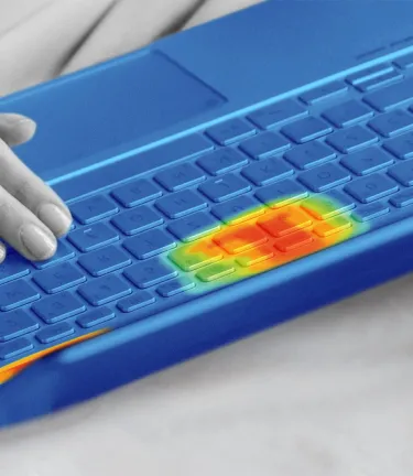 A monochrome photo of a person using a laptop