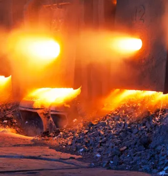 An active furnace with raw materials at the front.