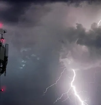 Telecommunications tower beside a storm